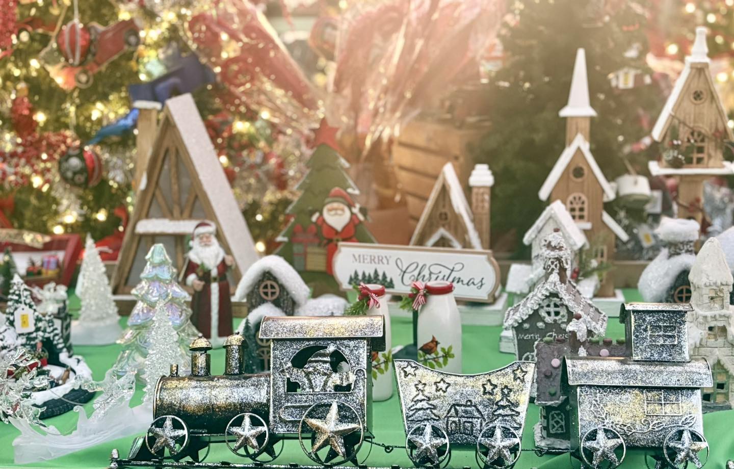 Christmas-themed miniature train set with decorative houses and trees.